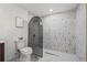 Modern bathroom with arch shower, decorative tile and marble flooring at 398 Walnut Ct, Palm Harbor, FL 34683