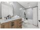 Updated bathroom with wood vanity, stylish tile, and modern fixtures at 398 Walnut Ct, Palm Harbor, FL 34683