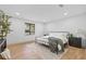 Comfortable bedroom with a metal bed frame, wood floors, and minimalist decor at 398 Walnut Ct, Palm Harbor, FL 34683