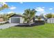 Charming single-story home featuring a well-manicured lawn, modern garage door, and attractive landscaping at 398 Walnut Ct, Palm Harbor, FL 34683