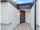 Inviting front entry with stylish tile flooring and modern wall lighting at 398 Walnut Ct, Palm Harbor, FL 34683