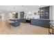 Well-appointed kitchen showcasing a large island, blue cabinetry, stainless appliances, and open shelving at 398 Walnut Ct, Palm Harbor, FL 34683