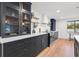 Close-up of a modern kitchen highlighting blue cabinets, quartz countertops, and stainless steel appliances at 398 Walnut Ct, Palm Harbor, FL 34683