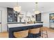 Stylish kitchen island featuring a white countertop, gold faucet, and woven barstools at 398 Walnut Ct, Palm Harbor, FL 34683