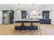 Bright, open kitchen with island, modern lighting, stainless steel appliances, and woven barstools at 398 Walnut Ct, Palm Harbor, FL 34683