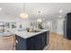 Navy kitchen island featuring white countertops, a gold faucet, and adjacent living area at 398 Walnut Ct, Palm Harbor, FL 34683