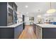Modern kitchen featuring stylish blue cabinets, quartz countertops, stainless steel appliances, and a large island with pendant lighting at 398 Walnut Ct, Palm Harbor, FL 34683