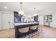 Modern kitchen with island seating, stylish pendant lights, and stainless steel appliances at 398 Walnut Ct, Palm Harbor, FL 34683