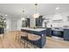 Stylish kitchen featuring a large island with seating, blue cabinets, and stainless steel appliances at 398 Walnut Ct, Palm Harbor, FL 34683