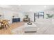 Bright living room featuring stylish furnishings, ample natural light, and a seamless flow to the dining area at 398 Walnut Ct, Palm Harbor, FL 34683
