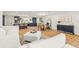 Bright, open-concept living area showcasing the kitchen, dining area, and comfortable seating space at 398 Walnut Ct, Palm Harbor, FL 34683