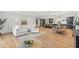 Spacious living room featuring a comfortable white sectional sofa and modern decor open to an eat-in kitchen at 398 Walnut Ct, Palm Harbor, FL 34683
