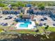 Aerial view of the condos with parking and a clubhouse featuring a community pool at 4004 Cortez Dr # D, Tampa, FL 33614