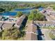 Stunning aerial view of lakeside apartments with lush greenery and a sparkling swimming pool at 4004 Cortez Dr # D, Tampa, FL 33614