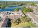 Aerial view of condos with parking and a pond in the background surrounded by trees at 4004 Cortez Dr # D, Tampa, FL 33614