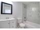 Bathroom features a vanity, toilet, tub/shower with stylish marble-look tile and modern fixtures at 4004 Cortez Dr # D, Tampa, FL 33614