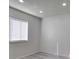 Bright bedroom features a large window, neutral walls, and modern wood-look flooring at 4004 Cortez Dr # D, Tampa, FL 33614