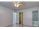 Clean bedroom featuring new gray wood-look floors, fresh paint, and an ensuite bathroom at 4004 Cortez Dr # D, Tampa, FL 33614