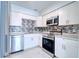 Updated kitchen featuring stainless steel appliances, marble countertops, and modern cabinetry at 4004 Cortez Dr # D, Tampa, FL 33614