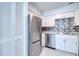 Updated kitchen featuring stainless steel appliances, marble countertops, and modern white cabinetry at 4004 Cortez Dr # D, Tampa, FL 33614
