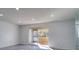 Bright living room featuring new gray wood-look floors and a sliding glass door to the outside at 4004 Cortez Dr # D, Tampa, FL 33614