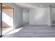 Bright living room featuring new gray wood-look floors, fresh paint, and a sliding glass door to the outside at 4004 Cortez Dr # D, Tampa, FL 33614