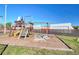 Community playground with swings, slide, climbing area, and wood chip ground cover at 4004 Cortez Dr # D, Tampa, FL 33614