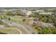 Aerial view showcasing community amenities, including tennis courts, a green, and convenient road access at 401 Dorchester Pl # 55, Sun City Center, FL 33573