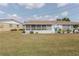 Spacious backyard featuring a screened lanai, lush lawn, and well-maintained landscaping at 401 Dorchester Pl # 55, Sun City Center, FL 33573
