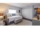 Stylized bedroom with daybed, upholstered storage bench, decorative pillows, side table, large window, and closet at 401 Dorchester Pl # 55, Sun City Center, FL 33573