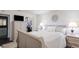 Comfortable bedroom featuring a queen bed, bedside tables with lamps, a wardrobe, and an open closet at 401 Dorchester Pl # 55, Sun City Center, FL 33573