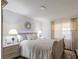 Comfortable bedroom featuring a queen bed, bedside tables with lamps, and sheer curtains that create a cozy and inviting ambiance at 401 Dorchester Pl # 55, Sun City Center, FL 33573