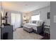 Stylized bedroom with daybed, upholstered storage bench, decorative pillows, side table, and large window at 401 Dorchester Pl # 55, Sun City Center, FL 33573
