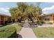 Beautifully maintained community pathway lined with mature trees and well-kept landscaping at 401 Dorchester Pl # 55, Sun City Center, FL 33573