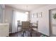 Cozy dining area featuring wicker chairs, dark floors, and ample natural light at 401 Dorchester Pl # 55, Sun City Center, FL 33573