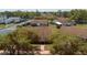Charming single-story home featuring a well-maintained lawn, pathway, and mature, flowering trees at 401 Dorchester Pl # 55, Sun City Center, FL 33573
