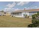 Well-maintained backyard with a screened-in lanai and green landscaping at 401 Dorchester Pl # 55, Sun City Center, FL 33573