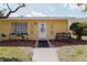 Charming single-story home featuring a well-manicured lawn and decorative accents surrounding the front door at 401 Dorchester Pl # 55, Sun City Center, FL 33573