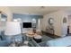 Cozy living room featuring comfortable blue furniture, dark flooring, and stylish accents at 401 Dorchester Pl # 55, Sun City Center, FL 33573