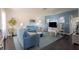 Bright living room featuring stylish blue furniture, dark floors, and coastal decor at 401 Dorchester Pl # 55, Sun City Center, FL 33573