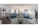 Bright living room with comfortable blue sofas, dark floors, and a lovely front window at 401 Dorchester Pl # 55, Sun City Center, FL 33573