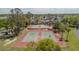 Aerial view of community tennis courts surrounded by trees on a sunny day in this active neighborhood at 401 Dorchester Pl # 55, Sun City Center, FL 33573