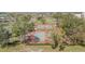 Overhead view of tennis courts surrounded by trees, providing a recreational amenity in this community at 401 Dorchester Pl # 55, Sun City Center, FL 33573