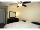 Bedroom view showcasing ceiling fan, dark dresser, and white bedding at 4338 Tahitian Gardens Cir # H, Holiday, FL 34691