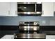 Close up of stainless steel microwave and oven with black countertops at 4338 Tahitian Gardens Cir # H, Holiday, FL 34691