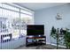 Living room with large window, exterior view and modern decor at 4338 Tahitian Gardens Cir # H, Holiday, FL 34691