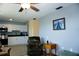 Living room with kitchen view, ceiling fan, and comfortable seating area at 4338 Tahitian Gardens Cir # H, Holiday, FL 34691
