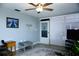 Living room area with ceiling fan, neutral decor, and sliding door at 4338 Tahitian Gardens Cir # H, Holiday, FL 34691