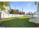 Fenced backyard with lush green grass, new grass and minimalist landscaping at 4405 W Euclid Ave, Tampa, FL 33629