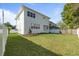 Spacious backyard with lush lawn, simple landscaping and white fence at 4405 W Euclid Ave, Tampa, FL 33629